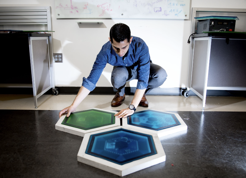 an Stern shows piezoelectric tiles that will be used to create a lighted outdoor footpath at the NASA Kennedy Space Center’s Visitor Complex at Cape Canaveral, Florida. Source: Branden Camp, Georgia Tech. 